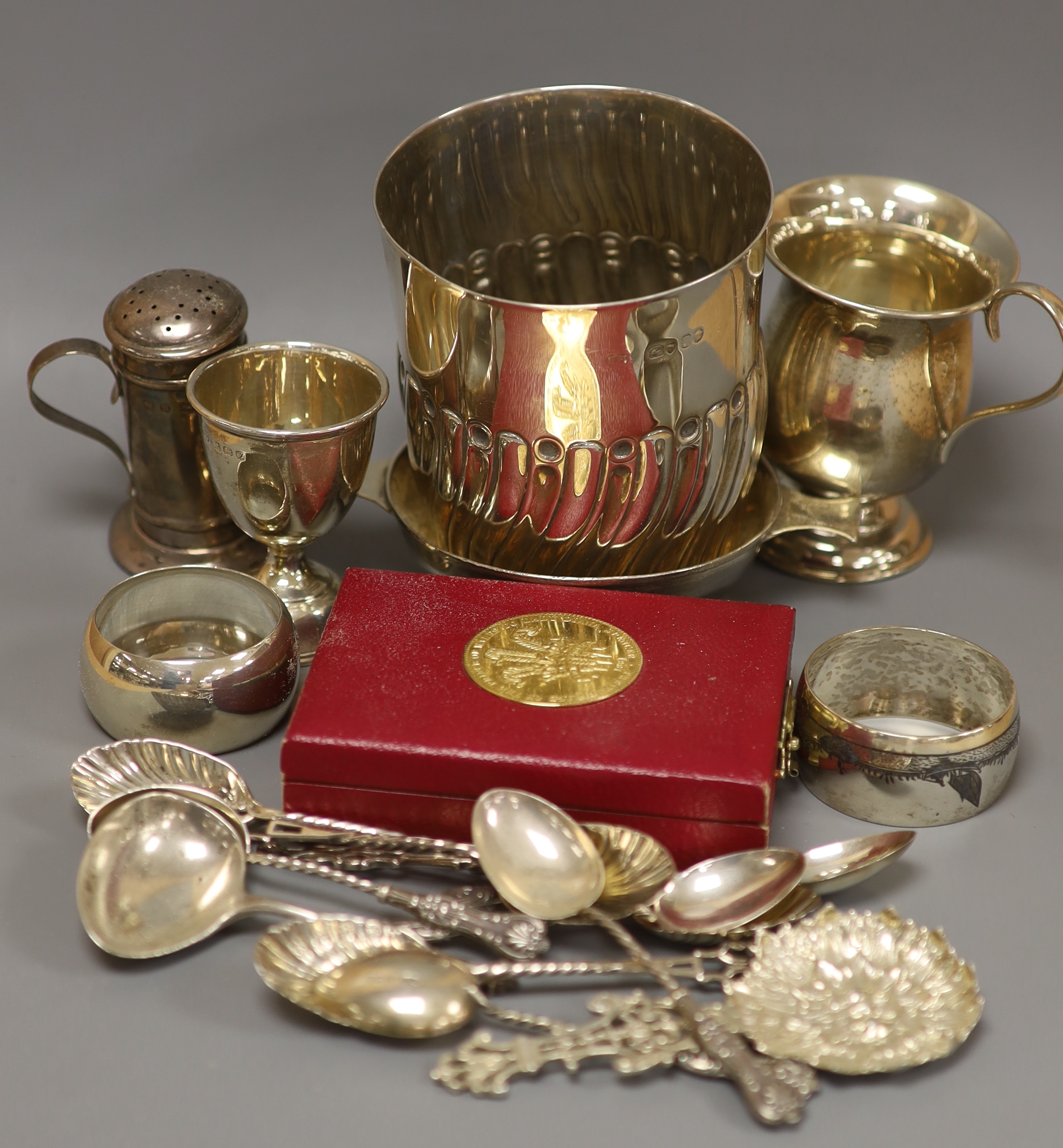 A Victorian silver half-fluted cylindrical vase, a small pedestal cup, a quaich, a Prince of Wales caddy spoon and other silver items
